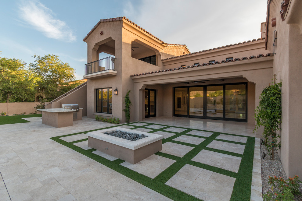 Example of a huge transitional beige two-story stucco house exterior design in Phoenix with a tile roof