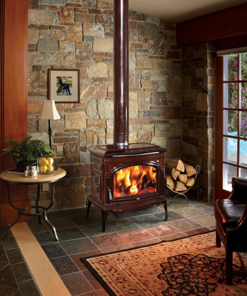 Photo of a country living room in Seattle with slate floors, a standard fireplace and a tile fireplace surround.
