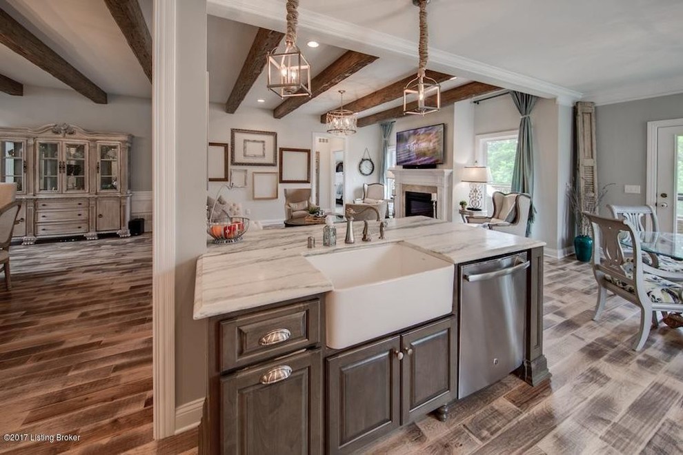 Eat-in kitchen - large rustic medium tone wood floor and brown floor eat-in kitchen idea in Louisville with a farmhouse sink, raised-panel cabinets, white cabinets, marble countertops, glass tile backsplash, stainless steel appliances and an island