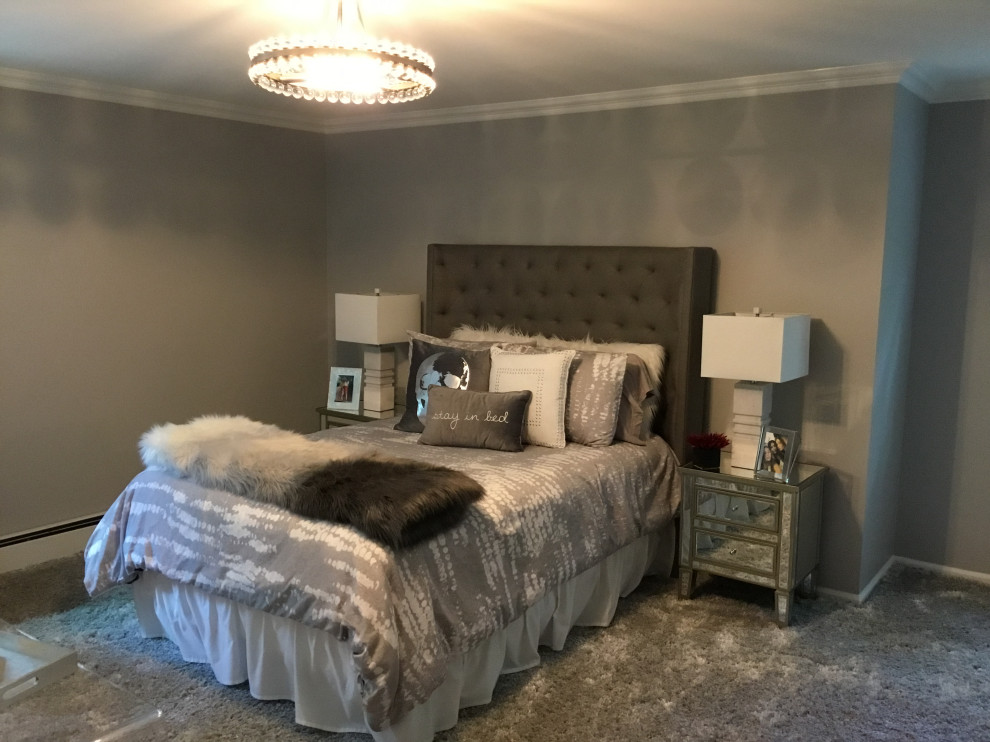 This is an example of a large modern bedroom in New York with grey walls, carpet and grey floor.
