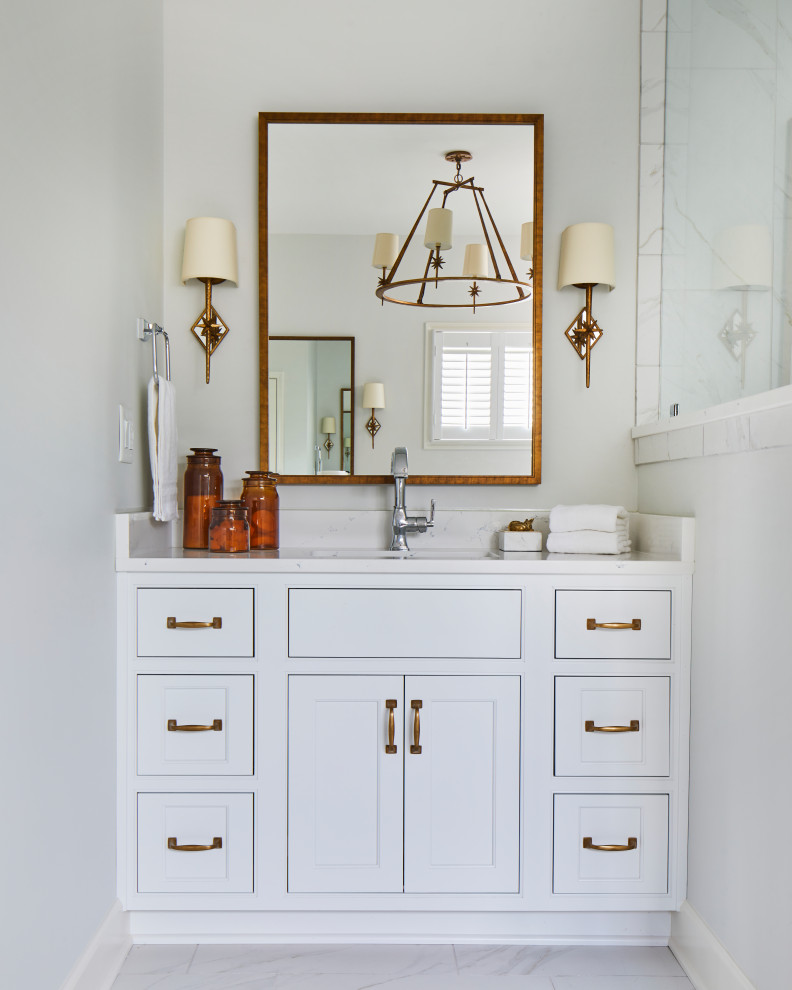 Inspiration for a large timeless master marble floor, white floor and double-sink bathroom remodel in Birmingham with recessed-panel cabinets, white cabinets, white walls, an undermount sink, marble countertops, a hinged shower door, white countertops and a built-in vanity
