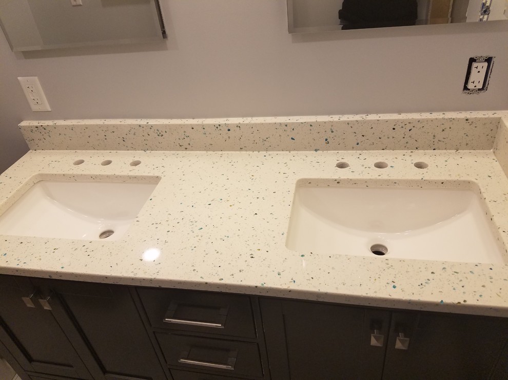 Example of a small transitional 3/4 blue tile and glass tile porcelain tile alcove shower design in Cincinnati with recessed-panel cabinets, black cabinets, a two-piece toilet, gray walls, an undermount sink and quartz countertops