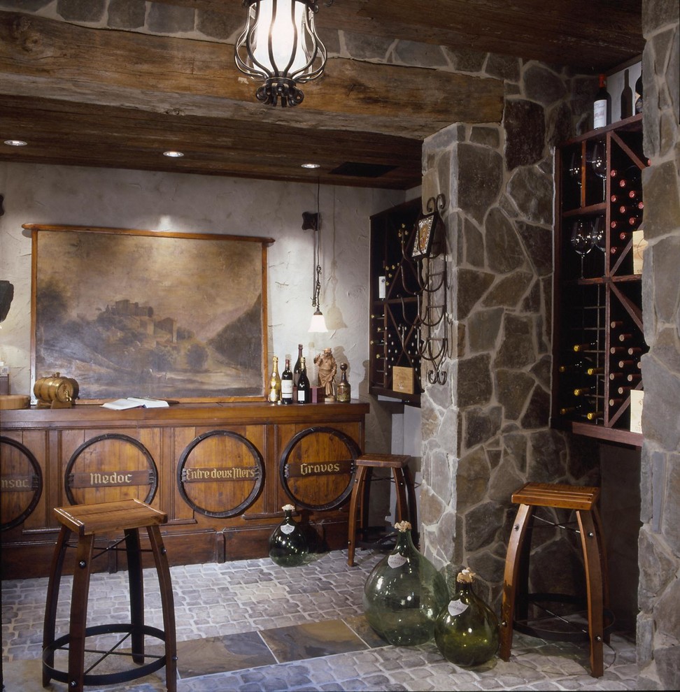 This is an example of a large mediterranean wine cellar in Baltimore with diamond bins, brick floors and grey floor.