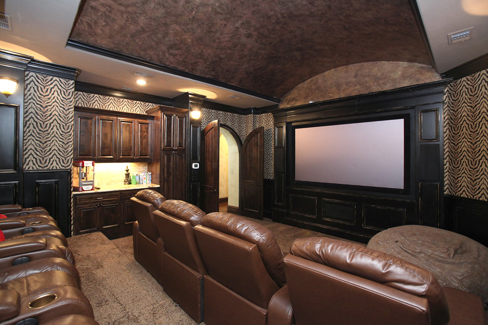 Large eclectic enclosed home theatre in Dallas with multi-coloured walls, carpet and a projector screen.