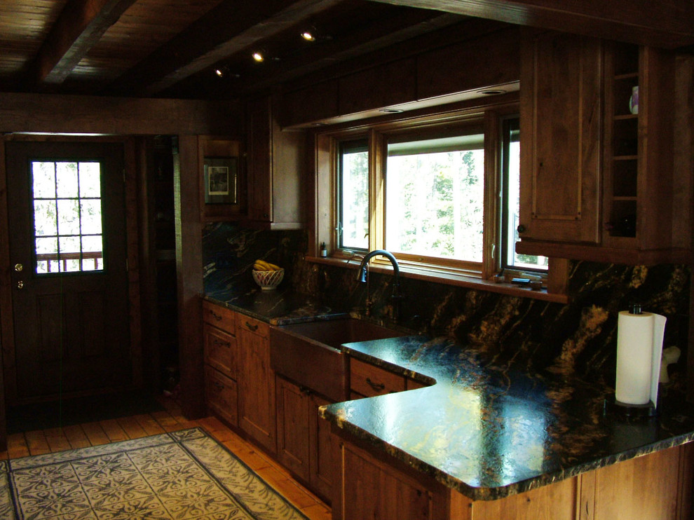 Inspiration for a mid-sized rustic u-shaped light wood floor kitchen pantry remodel in Denver with a farmhouse sink, flat-panel cabinets, dark wood cabinets, granite countertops, black backsplash, stone slab backsplash, stainless steel appliances and no island
