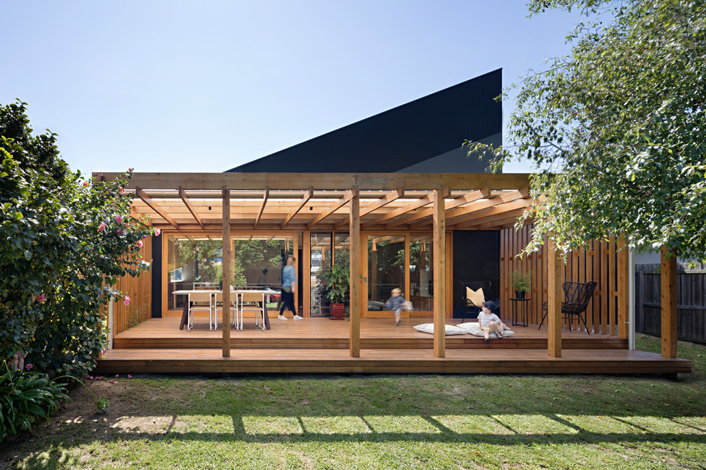 This is an example of a contemporary backyard deck in Geelong with a pergola.