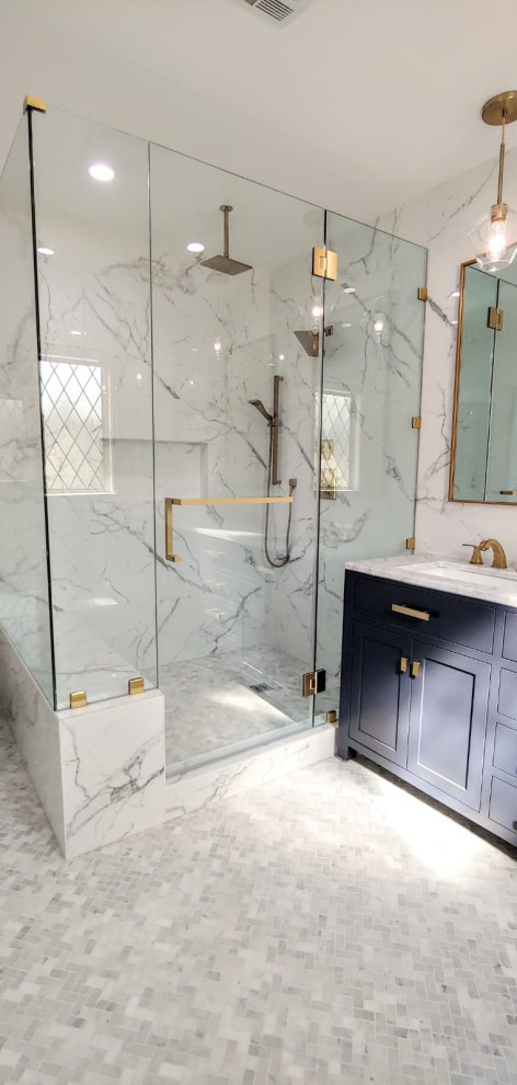 Medium sized modern ensuite bathroom in Los Angeles with shaker cabinets, blue cabinets, a corner shower, multi-coloured tiles, porcelain tiles, marble flooring, marble worktops, grey floors, a hinged door, white worktops, a shower bench, double sinks and a freestanding vanity unit.