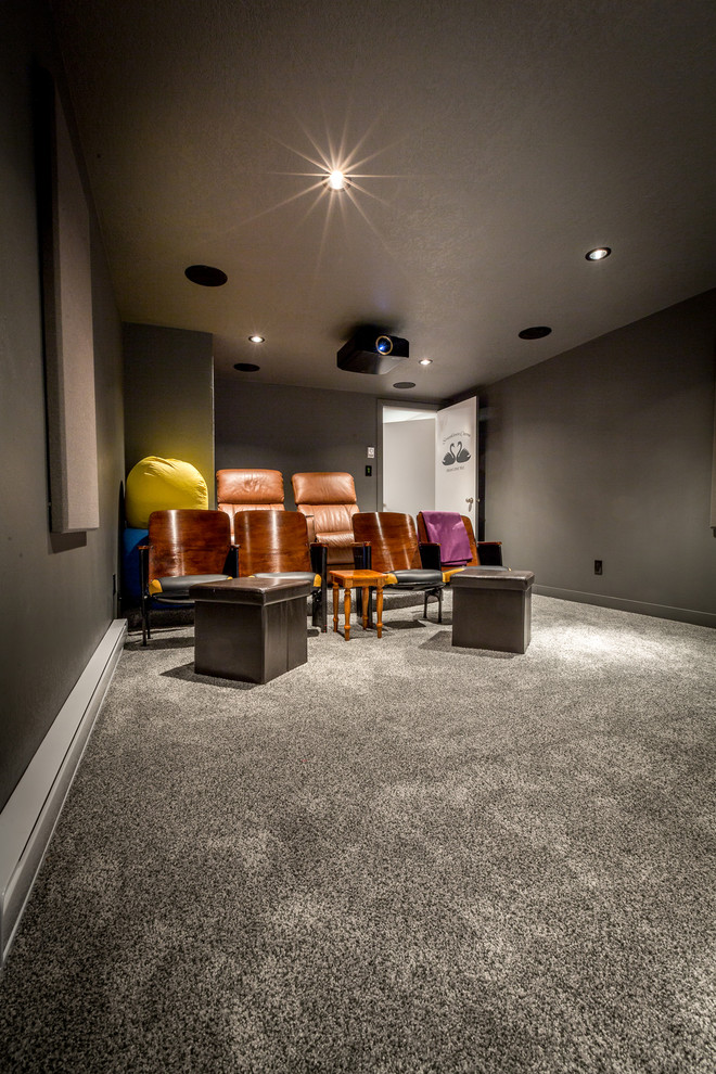 Photo of a mid-sized traditional enclosed home theatre in Calgary with grey walls, carpet, a projector screen and grey floor.