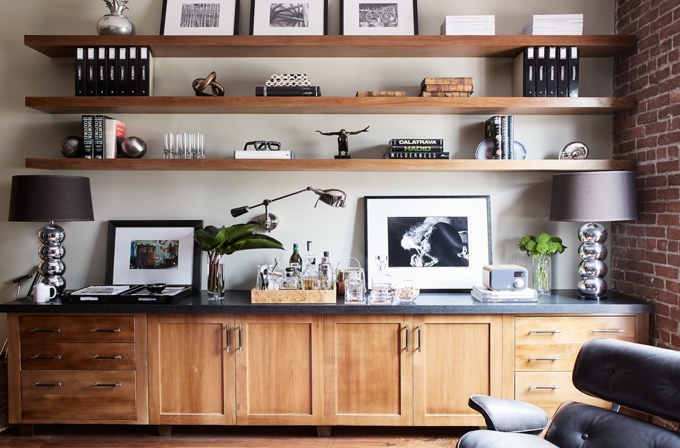 Inspiration for an industrial home office in San Francisco with medium hardwood floors, brown floor and beige walls.
