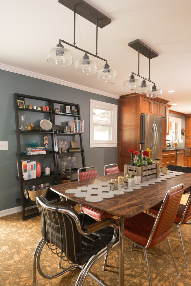 This is an example of a large eclectic kitchen/dining combo in Other with cork floors, grey walls, a standard fireplace and a wood fireplace surround.