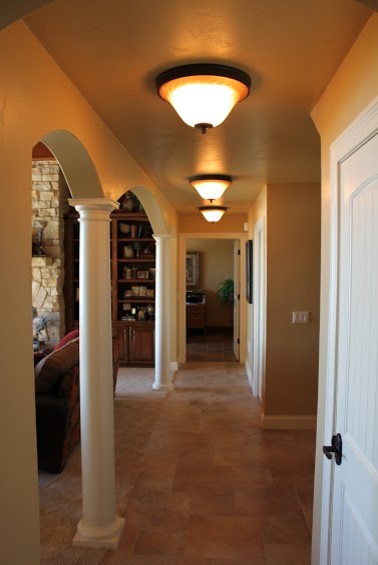 Inspiration for a mid-sized ceramic tile hallway remodel with beige walls