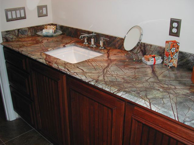 Mid-sized bathroom photo in Boston with an integrated sink, raised-panel cabinets, medium tone wood cabinets and white walls