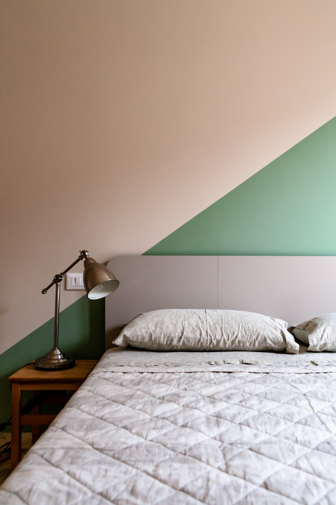 This is an example of a mid-sized modern master bedroom in Other with green walls, marble floors and pink floor.