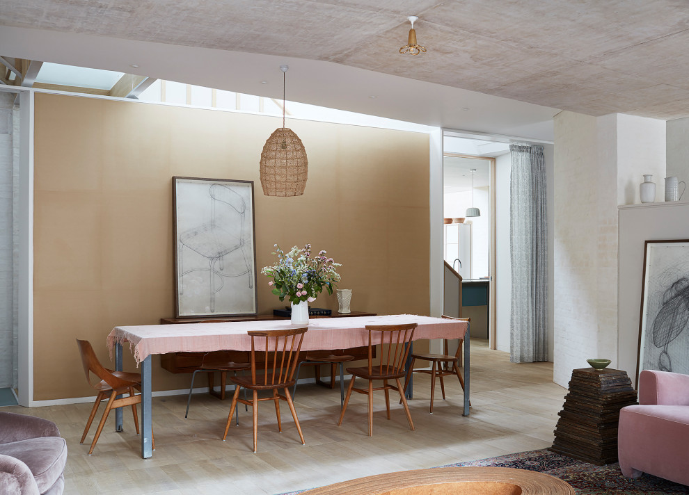 Photo of a large contemporary open plan dining in London with beige walls, beige floor and light hardwood floors.