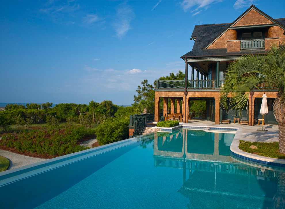 Expansive traditional custom-shaped infinity pool in Charleston.
