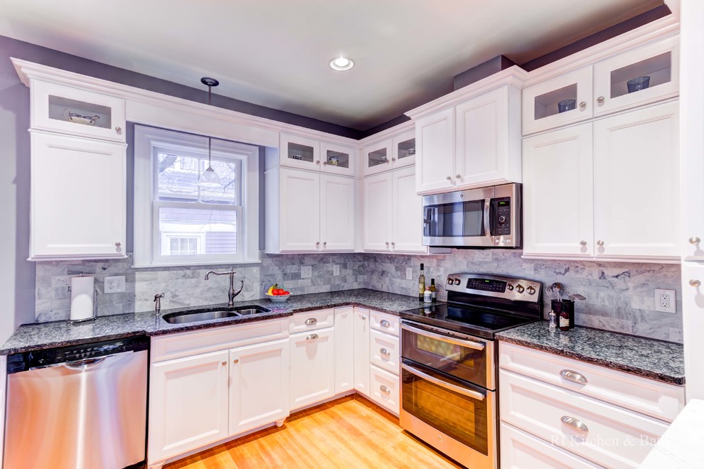 Example of a large transitional u-shaped medium tone wood floor eat-in kitchen design in Providence with an undermount sink, shaker cabinets, white cabinets, granite countertops, blue backsplash, stone tile backsplash, stainless steel appliances and an island