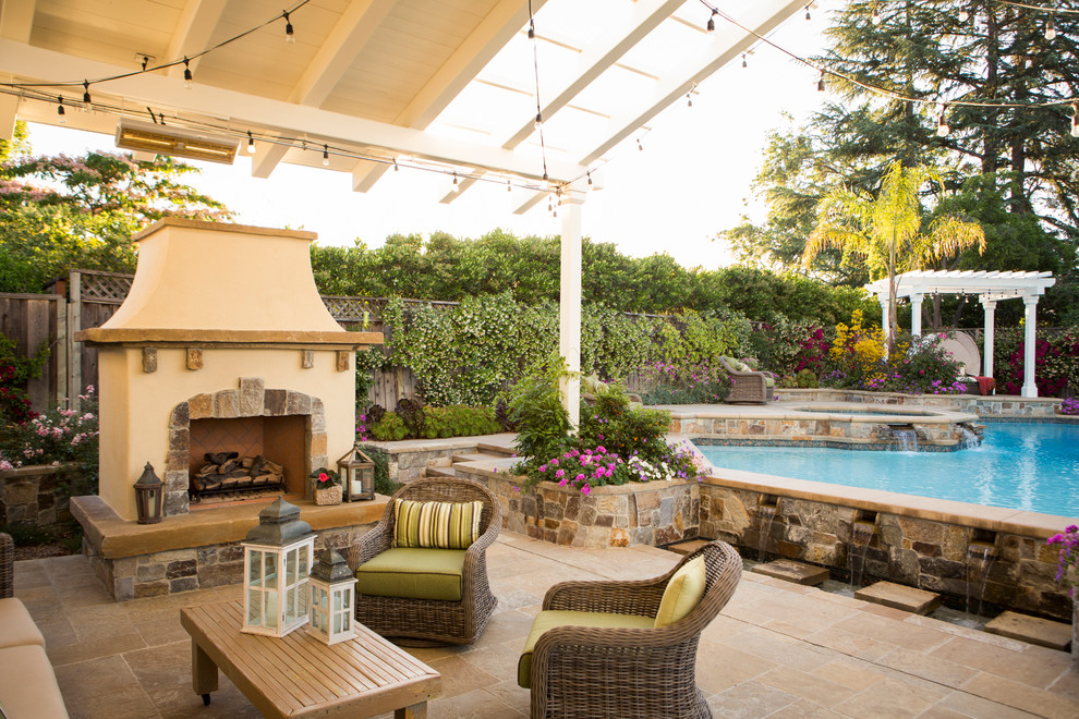 Traditional backyard patio in San Francisco with a pergola and natural stone pavers.
