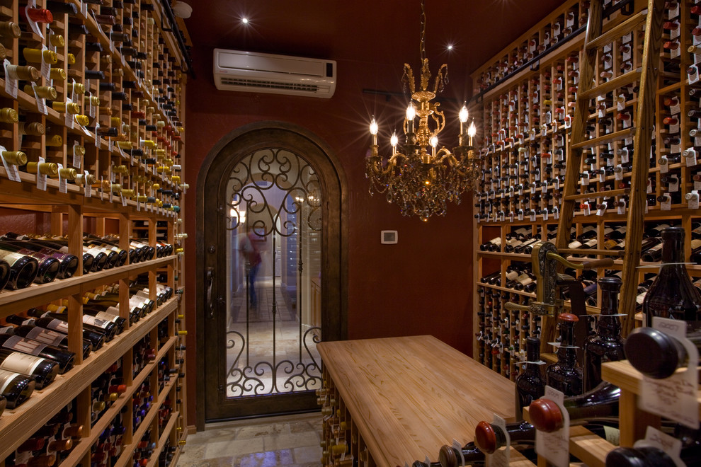Design ideas for a large traditional wine cellar in Phoenix with storage racks, limestone floors and beige floor.