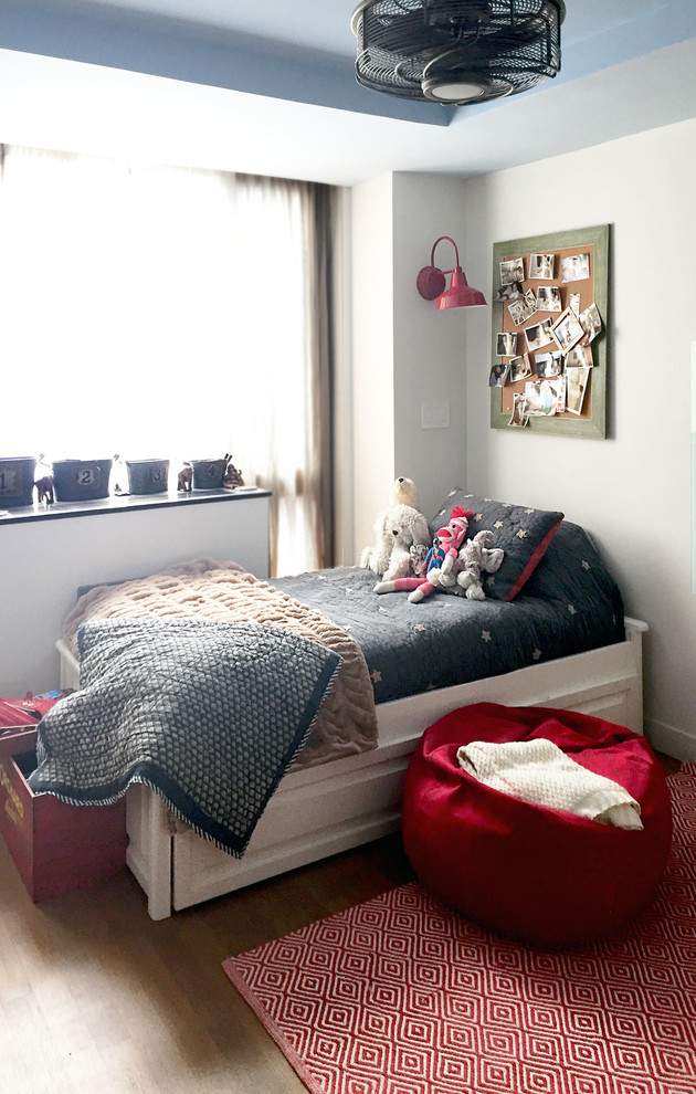 Photo of a mid-sized industrial kids' bedroom for kids 4-10 years old and boys in New York with white walls and medium hardwood floors.