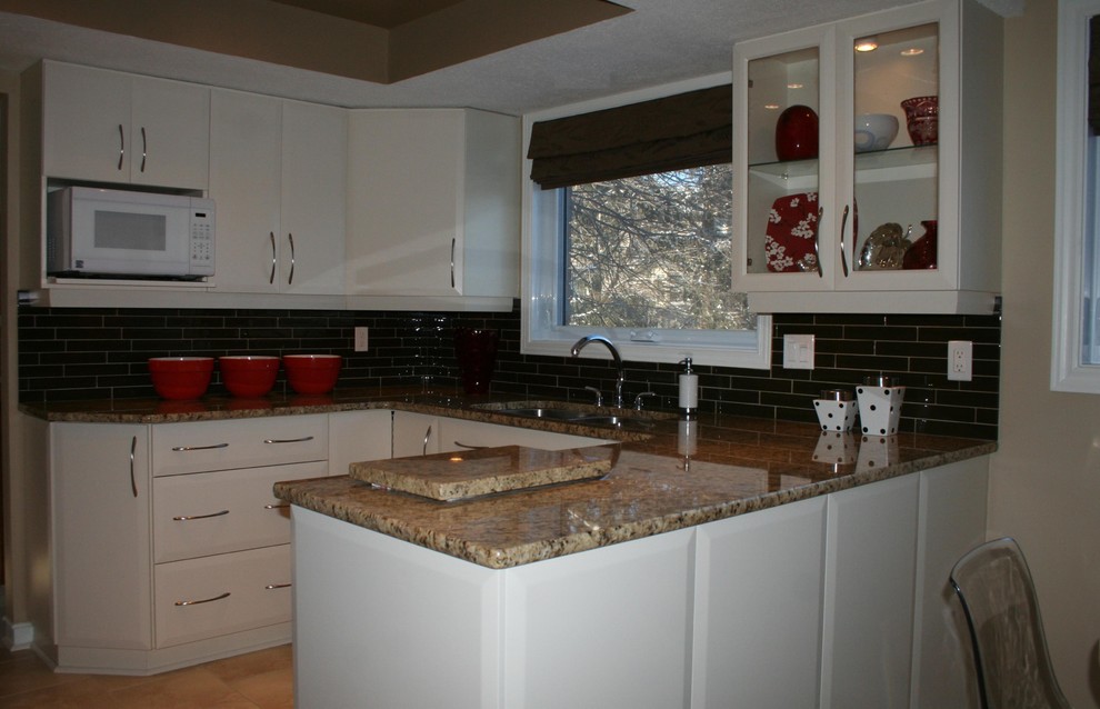 Photo of a small contemporary u-shaped separate kitchen in Ottawa with an undermount sink, flat-panel cabinets, beige cabinets, granite benchtops, brown splashback, glass tile splashback, white appliances, ceramic floors, a peninsula, beige floor, brown benchtop and coffered.
