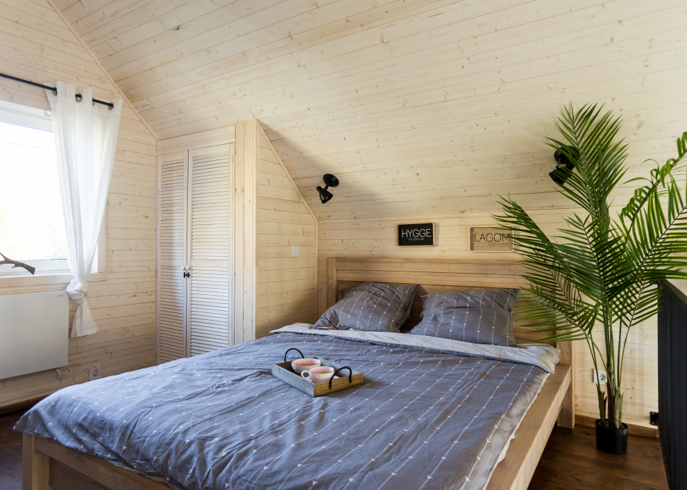 Inspiration for a small scandinavian master bedroom in Other with white walls and brown floor.