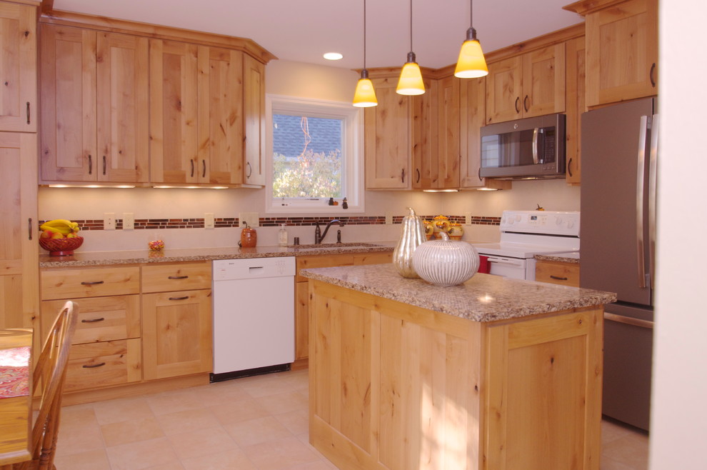 Inspiration for a transitional l-shaped porcelain tile eat-in kitchen remodel with an undermount sink, flat-panel cabinets, light wood cabinets, quartz countertops, beige backsplash, ceramic backsplash, white appliances and an island