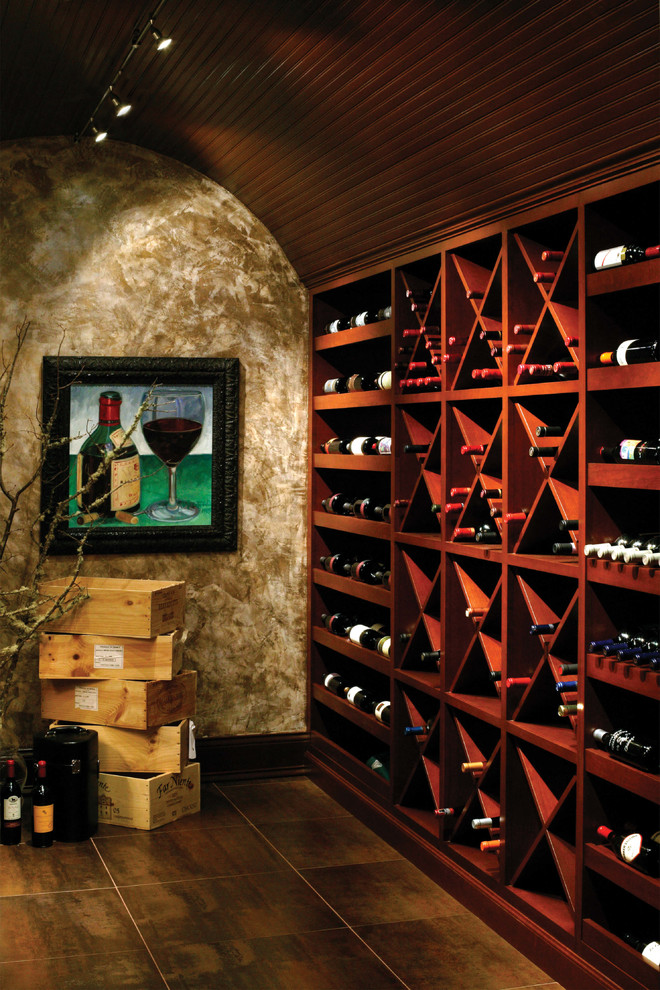 Inspiration for a small midcentury wine cellar in Chicago with terra-cotta floors and storage racks.