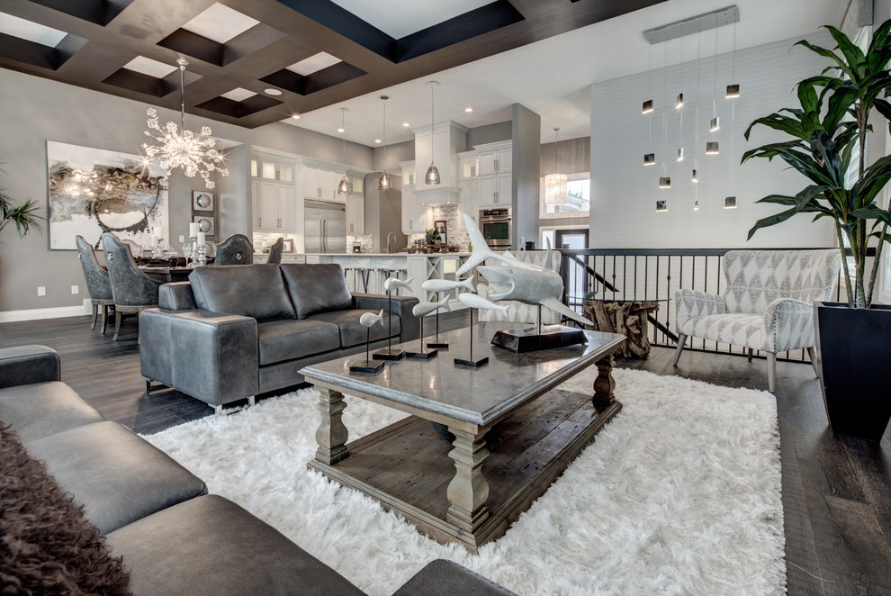 This is an example of a large transitional open concept family room in Edmonton with grey walls and dark hardwood floors.