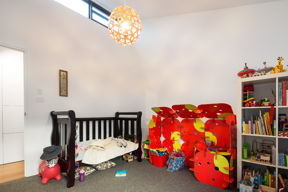 Photo of a contemporary gender-neutral kids' room in Melbourne with white walls and carpet.