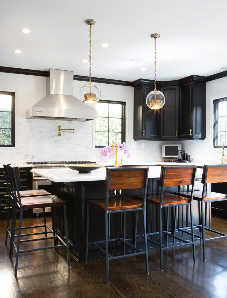 Example of a transitional dark wood floor kitchen design in Los Angeles with recessed-panel cabinets, black cabinets, white backsplash and stainless steel appliances