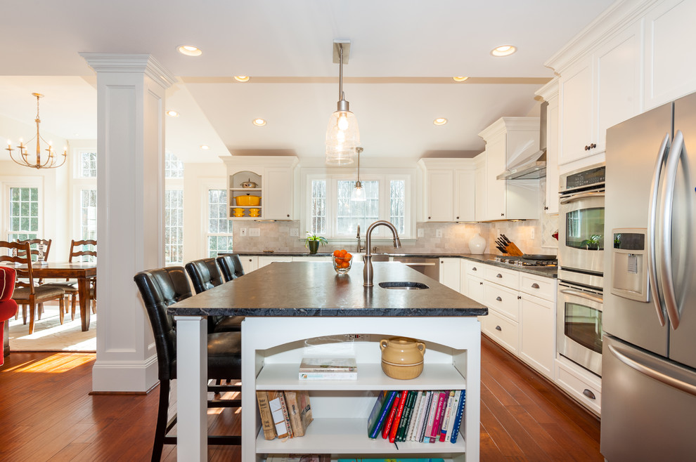 Photo of a mid-sized traditional l-shaped eat-in kitchen in DC Metro with ceramic splashback, stainless steel appliances, recessed-panel cabinets, white cabinets, marble benchtops, white splashback and with island.