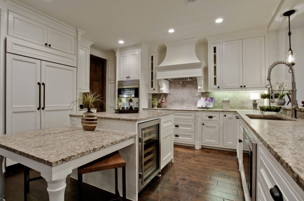 Mid-sized transitional u-shaped separate kitchen in Cleveland with an undermount sink, recessed-panel cabinets, white cabinets, laminate benchtops, grey splashback, porcelain splashback, stainless steel appliances, dark hardwood floors and multiple islands.