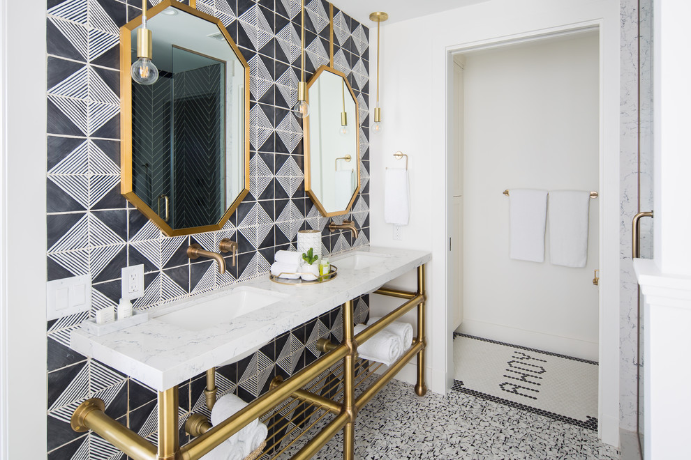 This is an example of a mid-sized beach style master bathroom in Orange County with black and white tile, white walls, an undermount sink, white floor, white benchtops, open cabinets, a claw-foot tub, a corner shower, a one-piece toilet, terra-cotta tile, mosaic tile floors, engineered quartz benchtops and a hinged shower door.