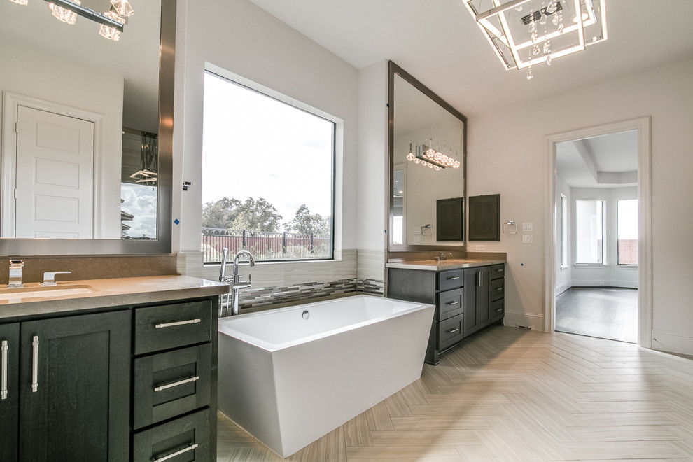Inspiration for a modern master bathroom in Houston with shaker cabinets, brown cabinets, a freestanding tub, a curbless shower, white tile, ceramic tile, white walls, ceramic floors, an undermount sink, quartzite benchtops, grey floor, a hinged shower door and brown benchtops.