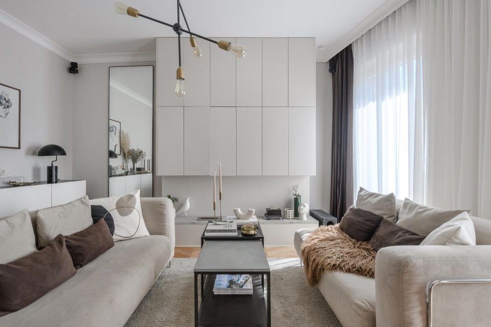 Inspiration for a small contemporary living room in Marseille with beige walls, light hardwood flooring and a concealed tv.