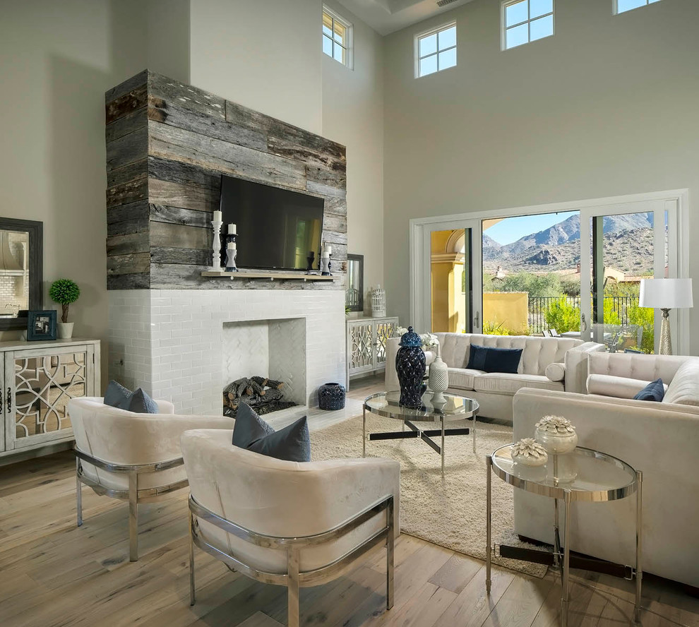 Photo of a transitional living room in Phoenix with grey walls, dark hardwood floors, a standard fireplace and a tile fireplace surround.