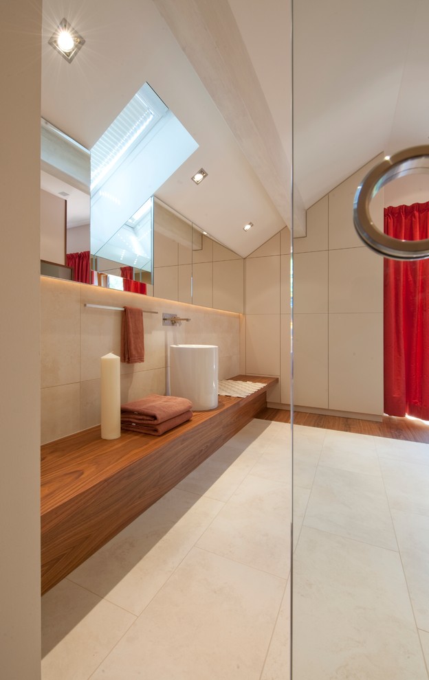 This is an example of a large contemporary bathroom in Munich with beige tile, stone tile, beige walls and wood benchtops.