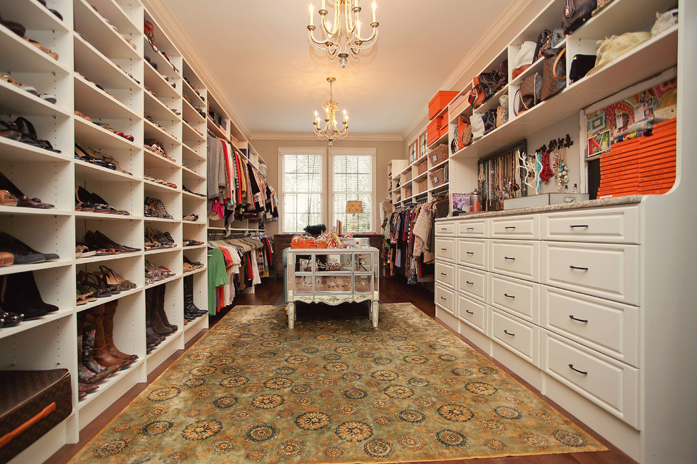 This is an example of a traditional storage and wardrobe in Charlotte with white cabinets.