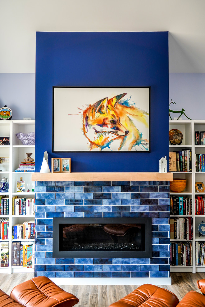Inspiration for a mid-sized transitional home studio in Minneapolis with blue walls, vinyl floors, a ribbon fireplace, a metal fireplace surround, a freestanding desk and brown floor.