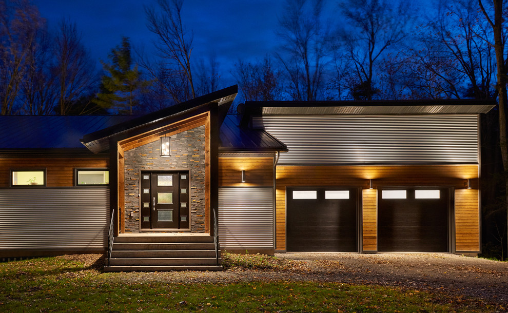Design ideas for a large contemporary one-storey grey exterior in Toronto with metal siding and a shed roof.