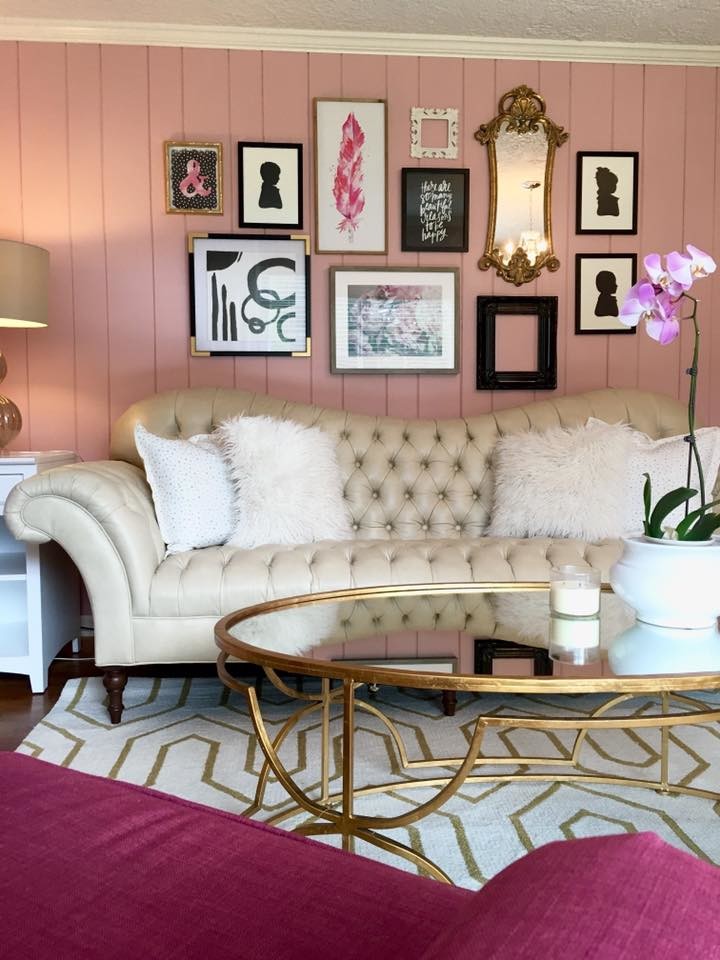 This is an example of a large transitional study room in Cleveland with pink walls, medium hardwood floors, no fireplace and a freestanding desk.