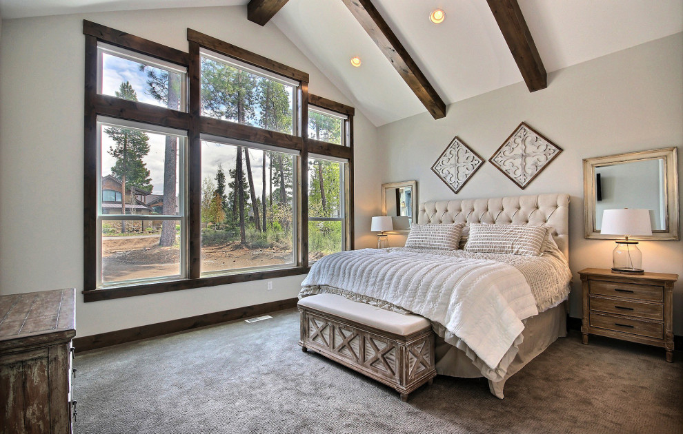 Inspiration for a large arts and crafts master bedroom in Portland with beige walls, carpet, no fireplace, brown floor and exposed beam.