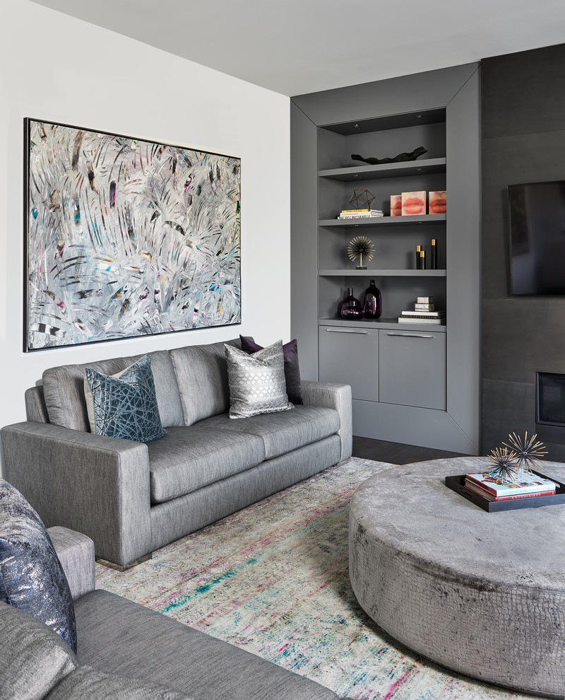 This is an example of a mid-sized contemporary open concept family room in Toronto with grey walls, dark hardwood floors, a ribbon fireplace, a metal fireplace surround, a wall-mounted tv and brown floor.