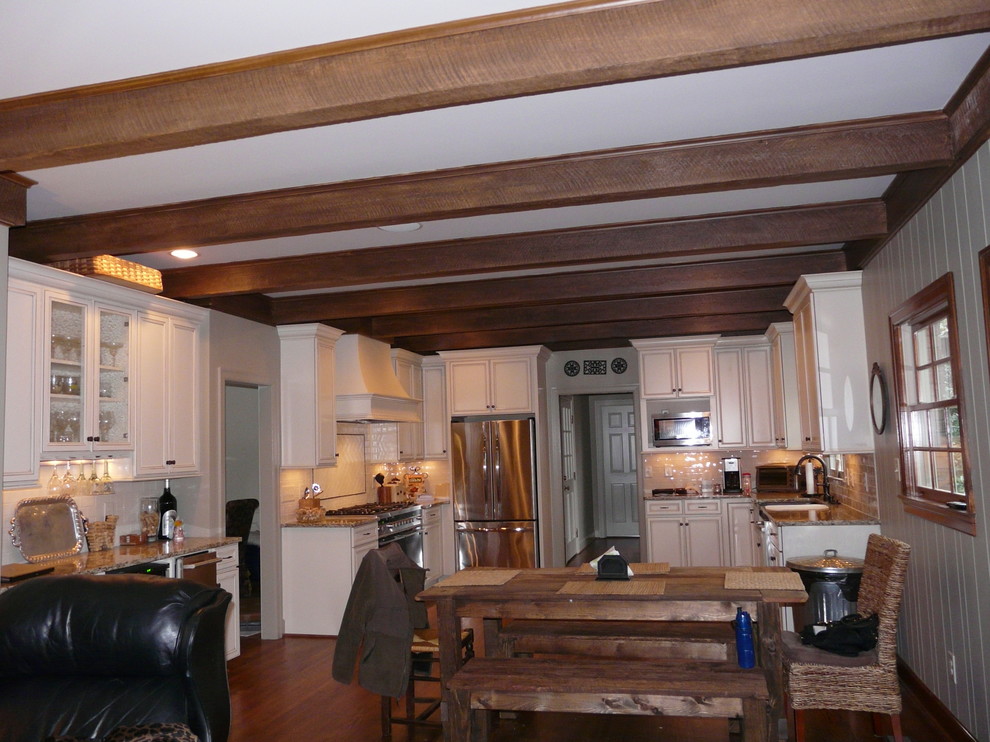 Transitional eat-in kitchen photo in Birmingham with a farmhouse sink, flat-panel cabinets, granite countertops, porcelain backsplash and stainless steel appliances