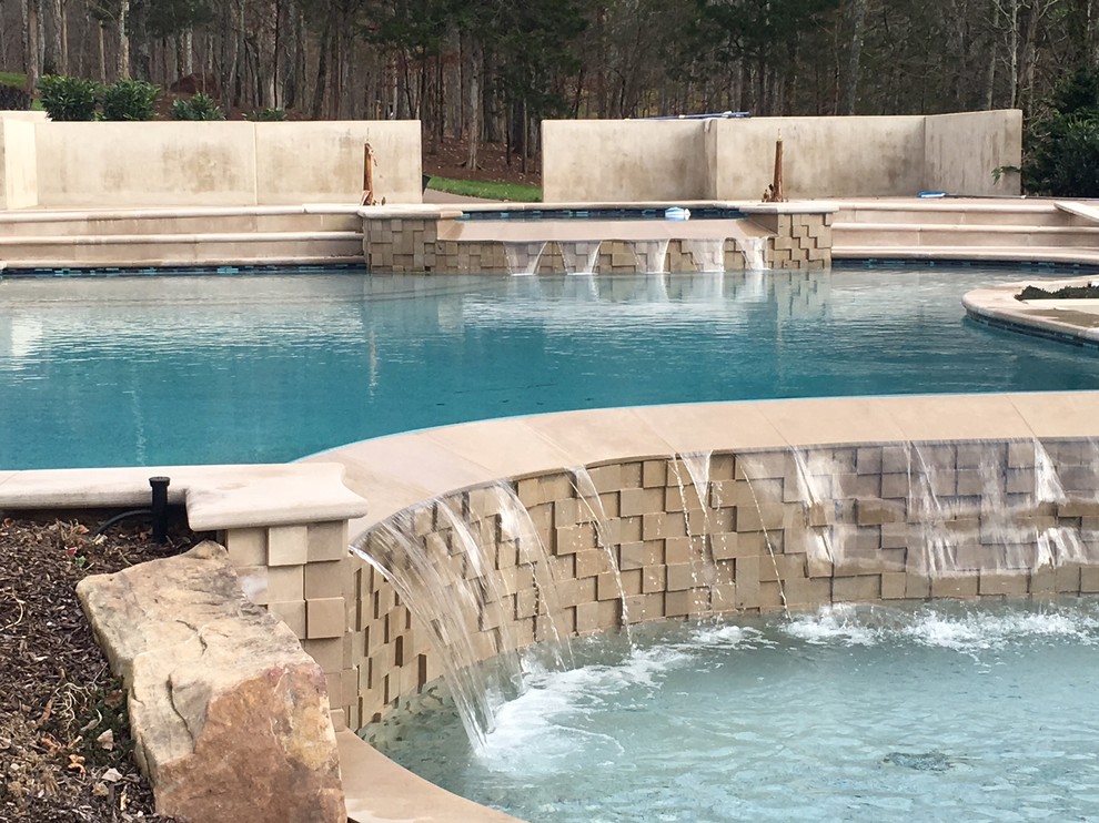 Mid-sized transitional backyard custom-shaped lap pool fountain photo in Nashville