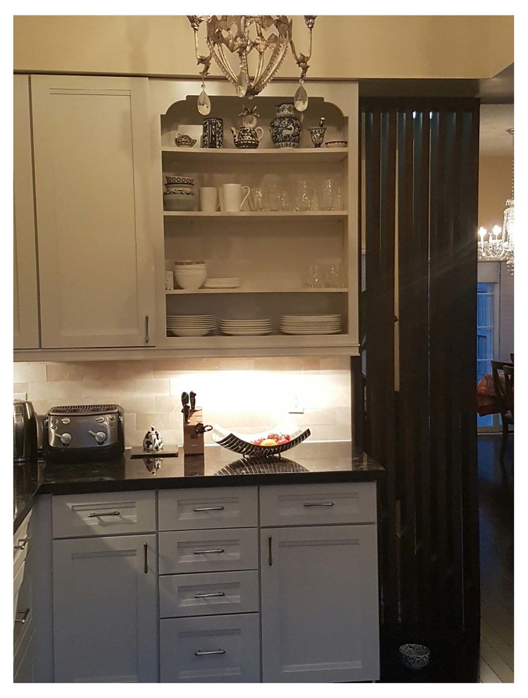 Eat-in kitchen - mid-sized transitional u-shaped dark wood floor eat-in kitchen idea in Toronto with an undermount sink, recessed-panel cabinets, white cabinets, granite countertops, beige backsplash, stone tile backsplash, a peninsula and stainless steel appliances