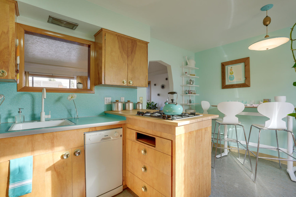 Inspiration for a mid-sized midcentury u-shaped eat-in kitchen in Portland with a drop-in sink, flat-panel cabinets, light wood cabinets, laminate benchtops, blue splashback, white appliances, linoleum floors, a peninsula and turquoise floor.
