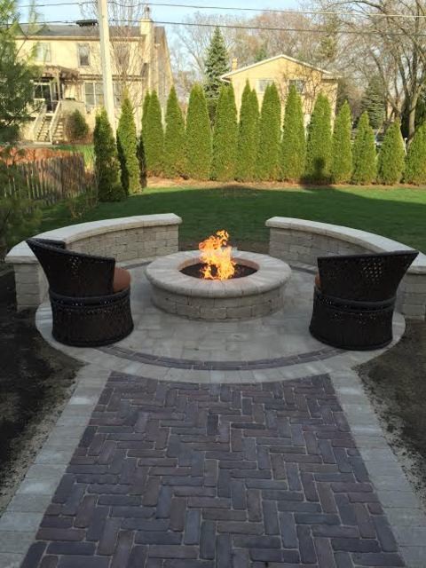Design ideas for a mid-sized transitional backyard patio in Chicago with a fire feature, concrete pavers and no cover.