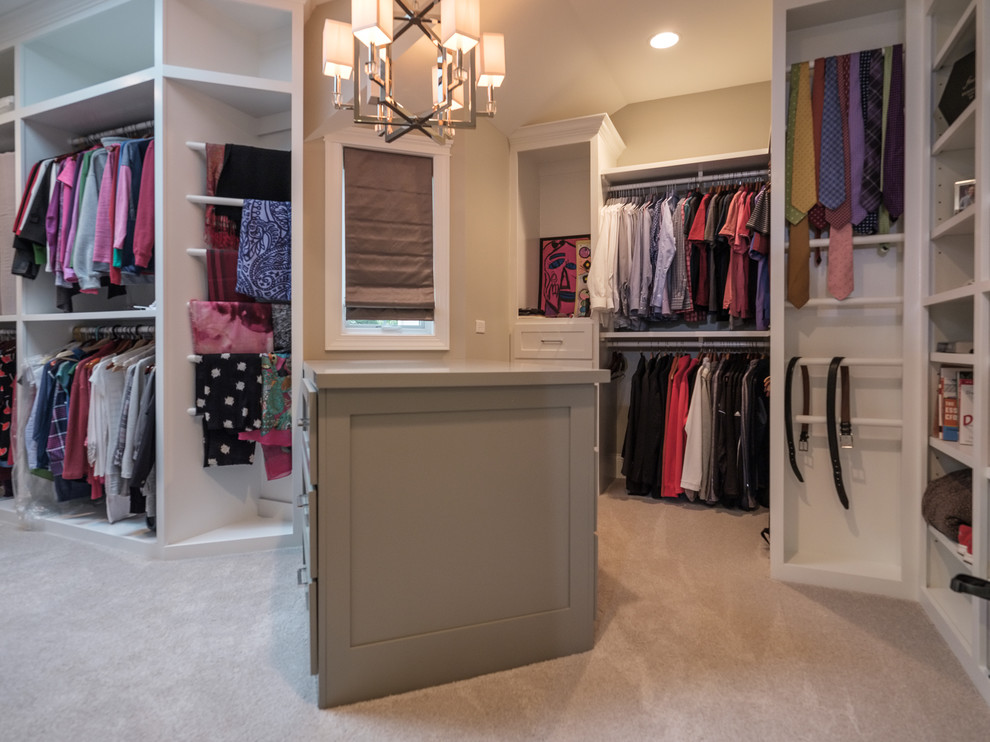 Large transitional gender-neutral walk-in wardrobe in Chicago with carpet, open cabinets, white cabinets and beige floor.