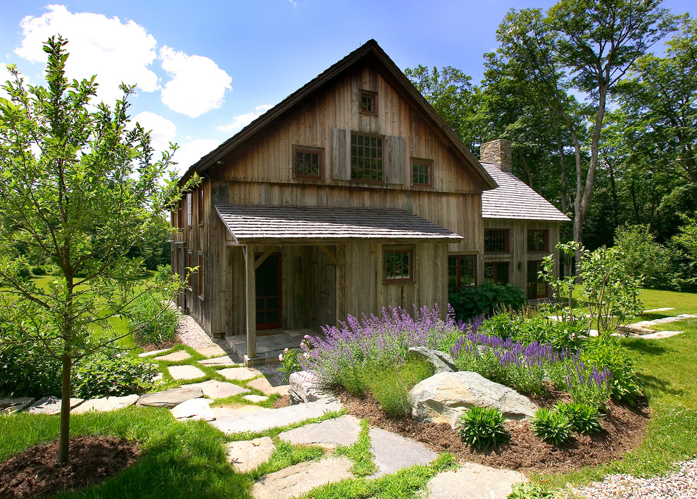 Inspiration for a mid-sized country two-storey brown exterior in New York with wood siding and a gable roof.